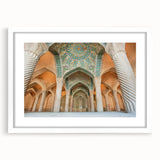 Abstract art print depicting a Middle Eastern scenery in muted earth tones on a framed white mat.