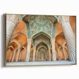 Framed canvas featuring a vintage-style landscape painting of a Middle Eastern scenery in muted gold and black tones.