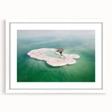 Abstract art print of the Dead Sea in muted blue and beige tones, framed with a white mat.