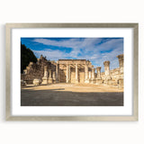 Textured art depicting an abstract Middle Eastern scenery in muted earth tones, framed with a silver mat.