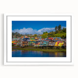 Abstract art print of Santiago skyline in muted blue and gray tones on a framed white mat, ideal for dining room decor.