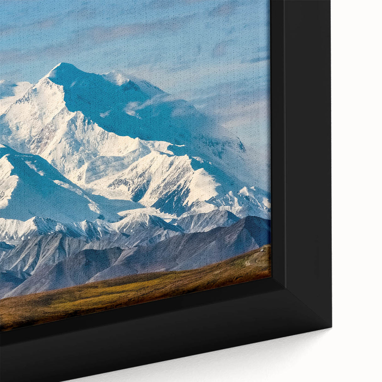 Close-up of black wall art featuring textured, colorful depiction of Denali, Alaska on a large framed canvas.
