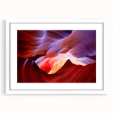 Abstract art print of Arizona Antelope Canyon in red and orange tones on a framed white mat.