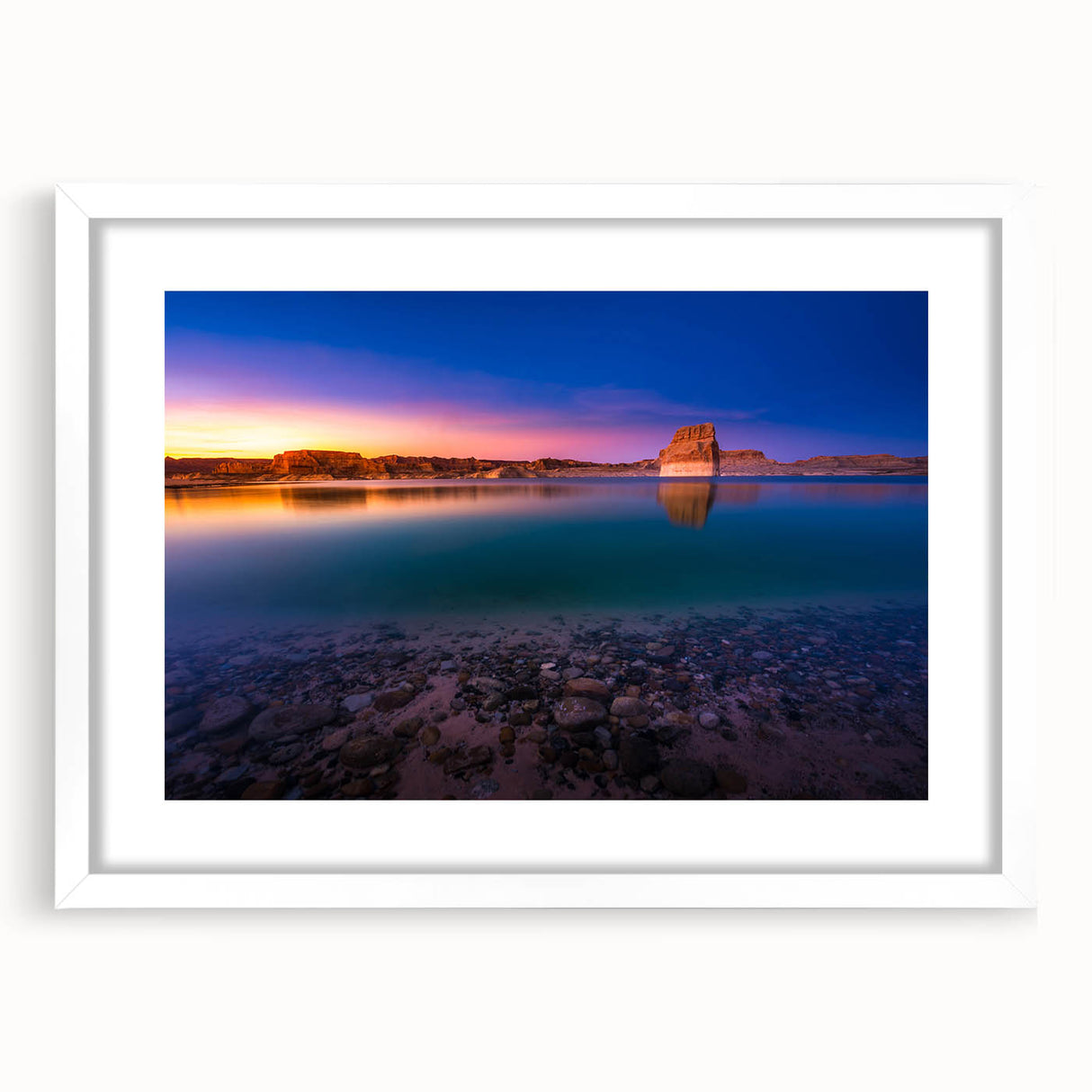 Abstract art print of Lake Powell with muted blue and beige tones on a framed white mat, suitable for dining room decor.