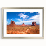 Textured art print depicting Monument Valley in muted earth tones on a framed canvas, suitable for bedroom decor.