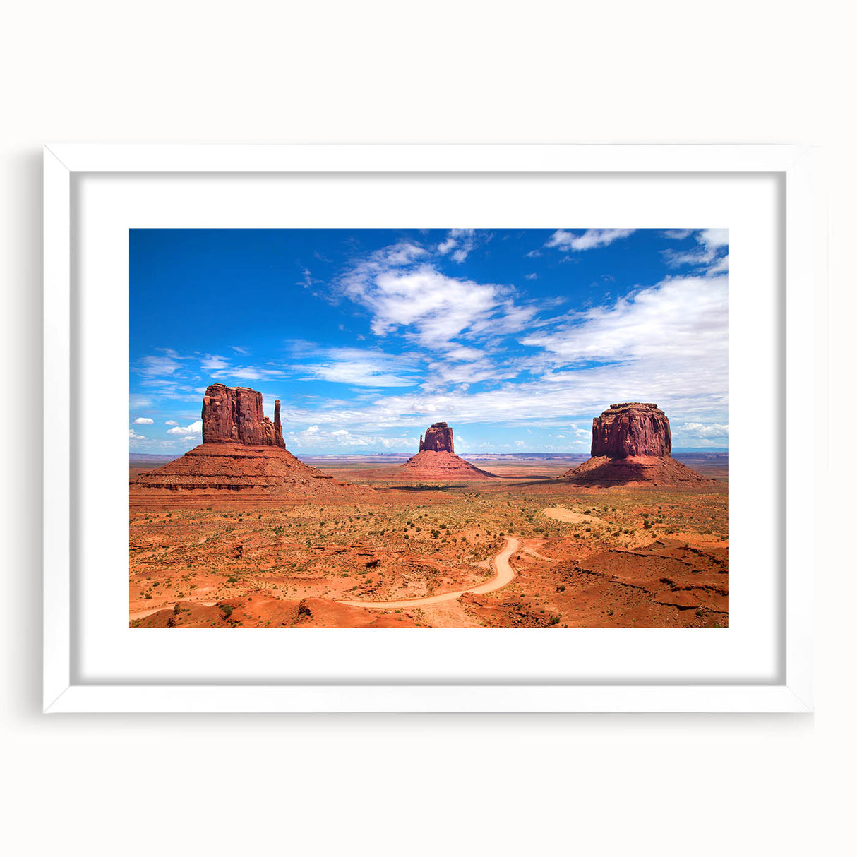 Abstract art print of Monument Valley in muted earth tones on a framed white mat, suitable for bedroom or dining room decor.