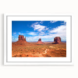 Abstract art print of Monument Valley in muted earth tones on a framed white mat, suitable for bedroom or dining room decor.