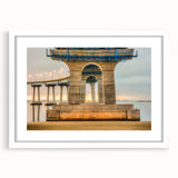 Abstract art print featuring a muted palette of blues and grays, framed in white, ideal for bedroom or dining room decor.