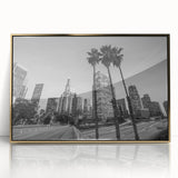 Large art print of Los Angeles skyline in gold and blue tones on acrylic, framed, in mid-century modernist style.