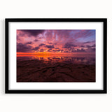 Colorful abstract art print of Santa Cruz scenery in a black frame, ideal for living room decor.
