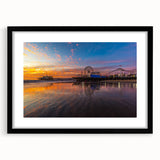 Colorful abstract art print of Santa Monica scenery in a black frame, ideal for living room decor.