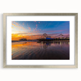 Textured abstract art print of Santa Monica in muted blue and gray, framed in silver, ideal for bedroom decor.