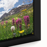 Close-up of a black wall art depicting Aspen, Colorado scenery in vibrant colors on framed canvas.