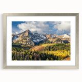 Textured art depicting the Rocky Mountains in muted earth tones on a framed silver mat, suitable for bedroom art.