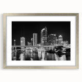 Textured abstract art print of Tampa scenery in muted blues and grays on a framed silver mat, suitable for bedroom decor.