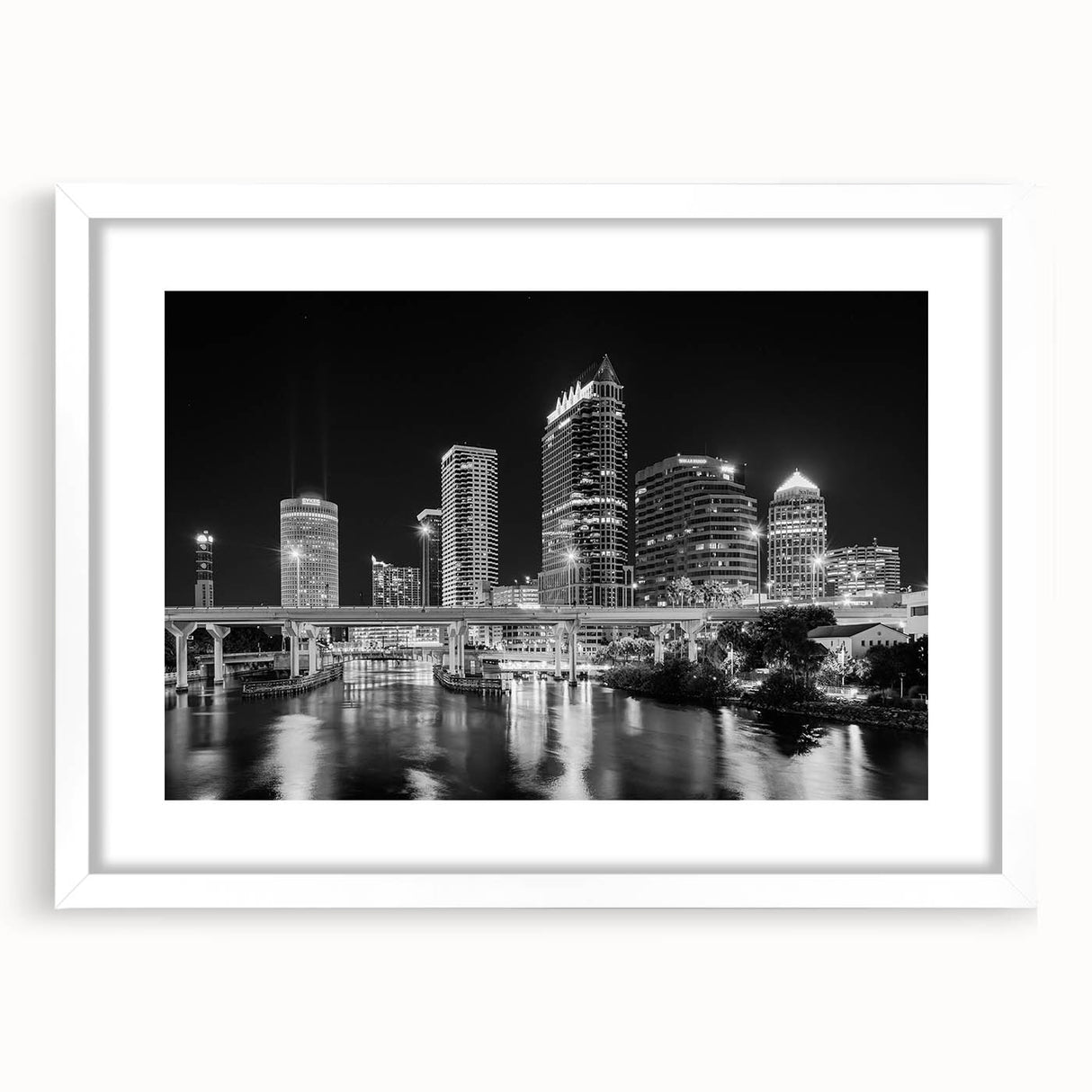 Abstract art print of Tampa skyline in muted blue and gray tones on a framed white canvas.