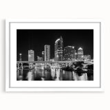 Abstract art print of Tampa skyline in muted blue and gray tones on a framed white canvas.