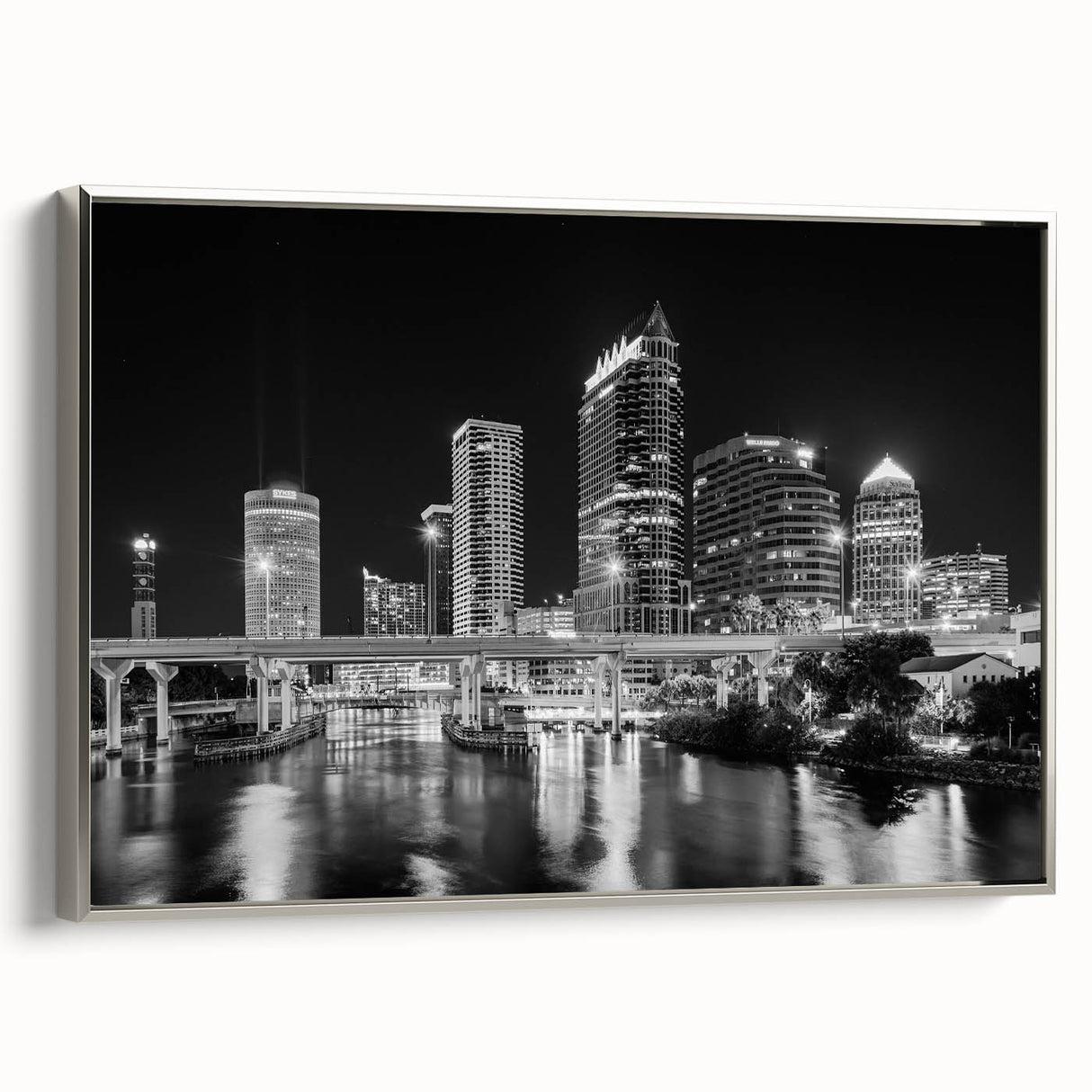 Framed canvas of Tampa landscape with silver frame, featuring colorful art in a vintage poster style.
