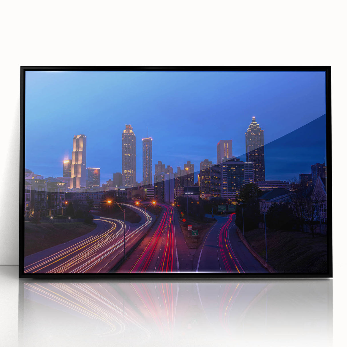 Large abstract wall art of Atlanta skyline in muted gray and blue tones on framed acrylic.