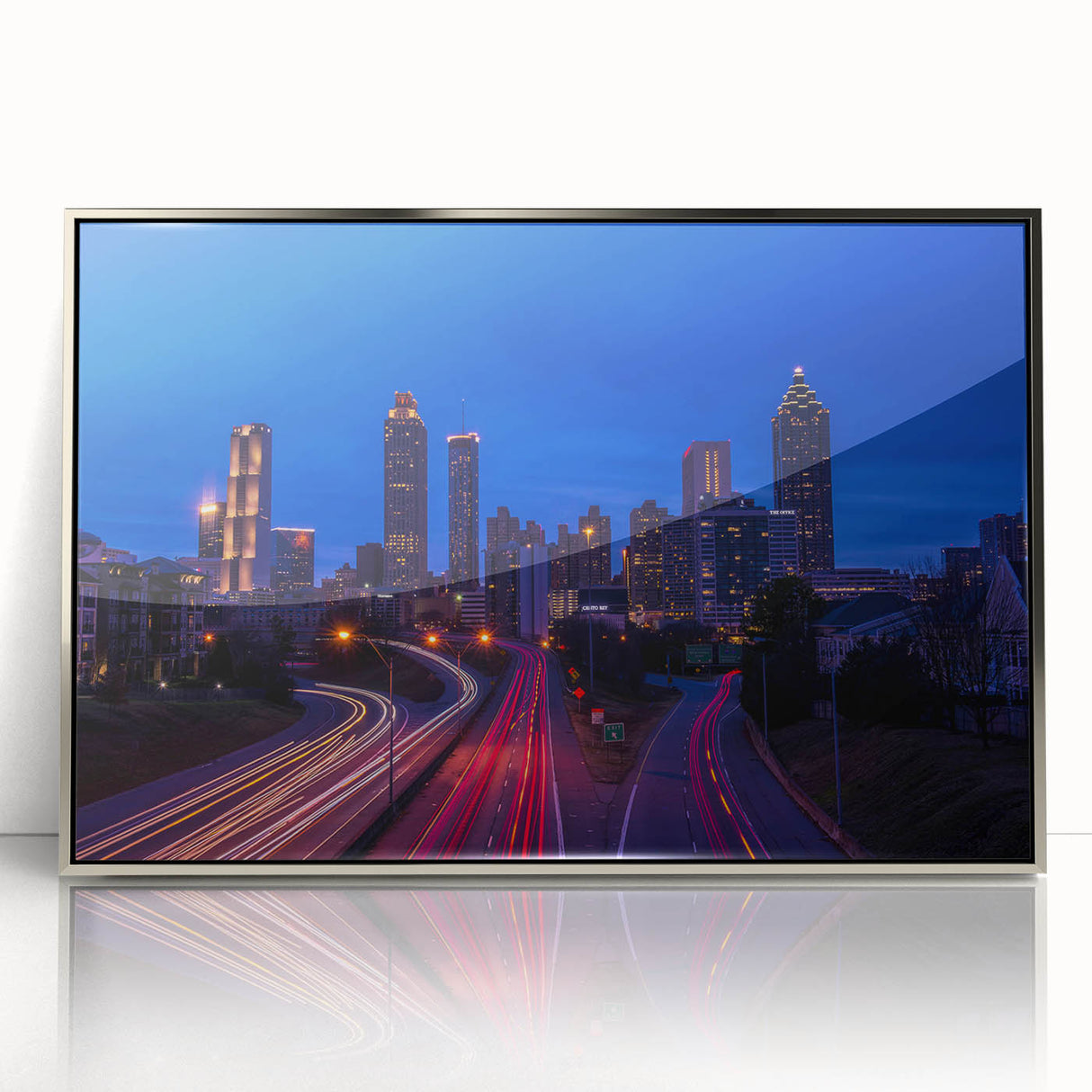 Mid-century modernist art of Atlanta skyline in muted gray and blue tones, acrylic print framed in silver.