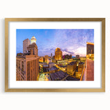 Abstract art print of New Orleans landscape in gold frame, utilizing textured blues and greens.