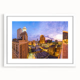 Abstract art print of New Orleans skyline in muted gray and blue tones on a framed white mat, suitable for dining room decor.