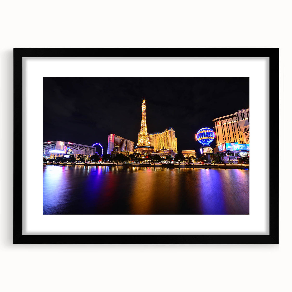Extra large abstract art print of colorful Las Vegas skyline on textured canvas, framed in black.