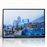 Large abstract wall art of Charlotte skyline in acrylic with black frame, featuring muted gray and blue tones.