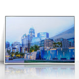 Art deco poster of Charlotte, North Carolina skyline in muted gray tones on a framed acrylic.