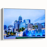 Vintage poster art of Charlotte skyline in colorful hues on framed canvas, ideal for living room decor.