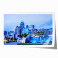 Rolled print of Charlotte, North Carolina skyline in muted blue tones, suitable for dining room wall art.