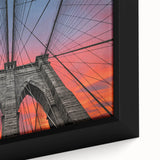 Close-up of a black wall art featuring the Brooklyn Bridge in textured, colorful art on a framed canvas.