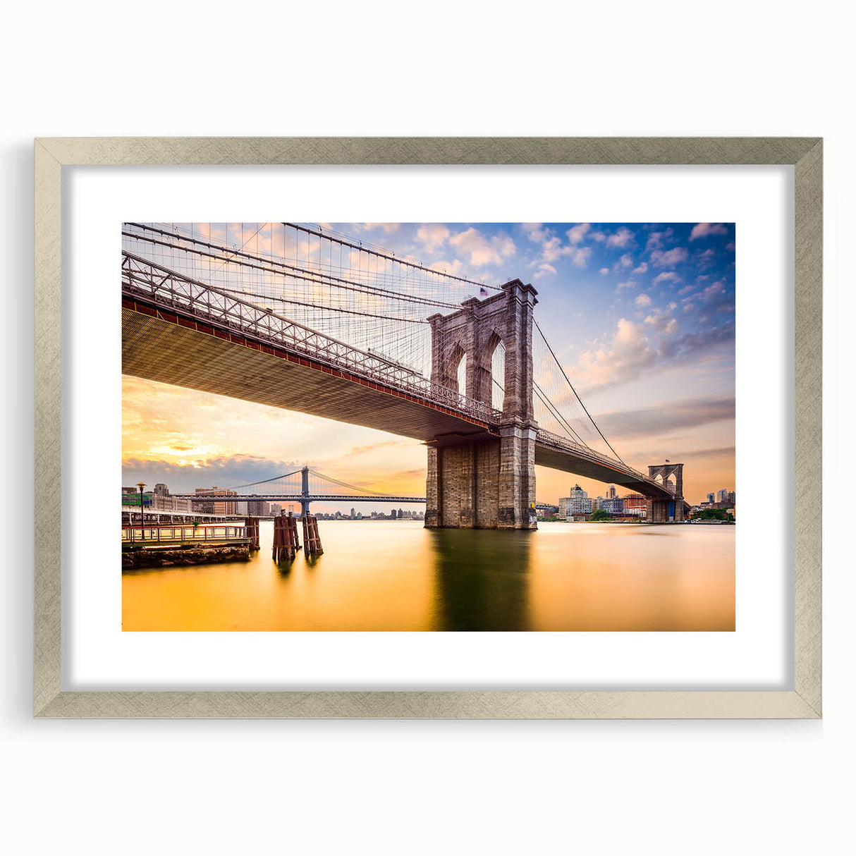 Textured art print of the Manhattan Bridge in muted grays and blues on a framed silver mat, suitable for bedroom decor.