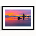 Colorful abstract art print of Cannon Beach, Oregon, in vibrant hues on textured canvas, framed in black.