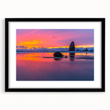 Colorful abstract art print of Cannon Beach, Oregon, in vibrant hues on textured canvas, framed in black.