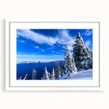 Abstract art print of Crater Lake in muted blue and green tones, framed with a white mat.