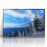 Mid-century modernist art depicting Crater Lake, Oregon in muted blue and green tones on a silver-framed acrylic print.