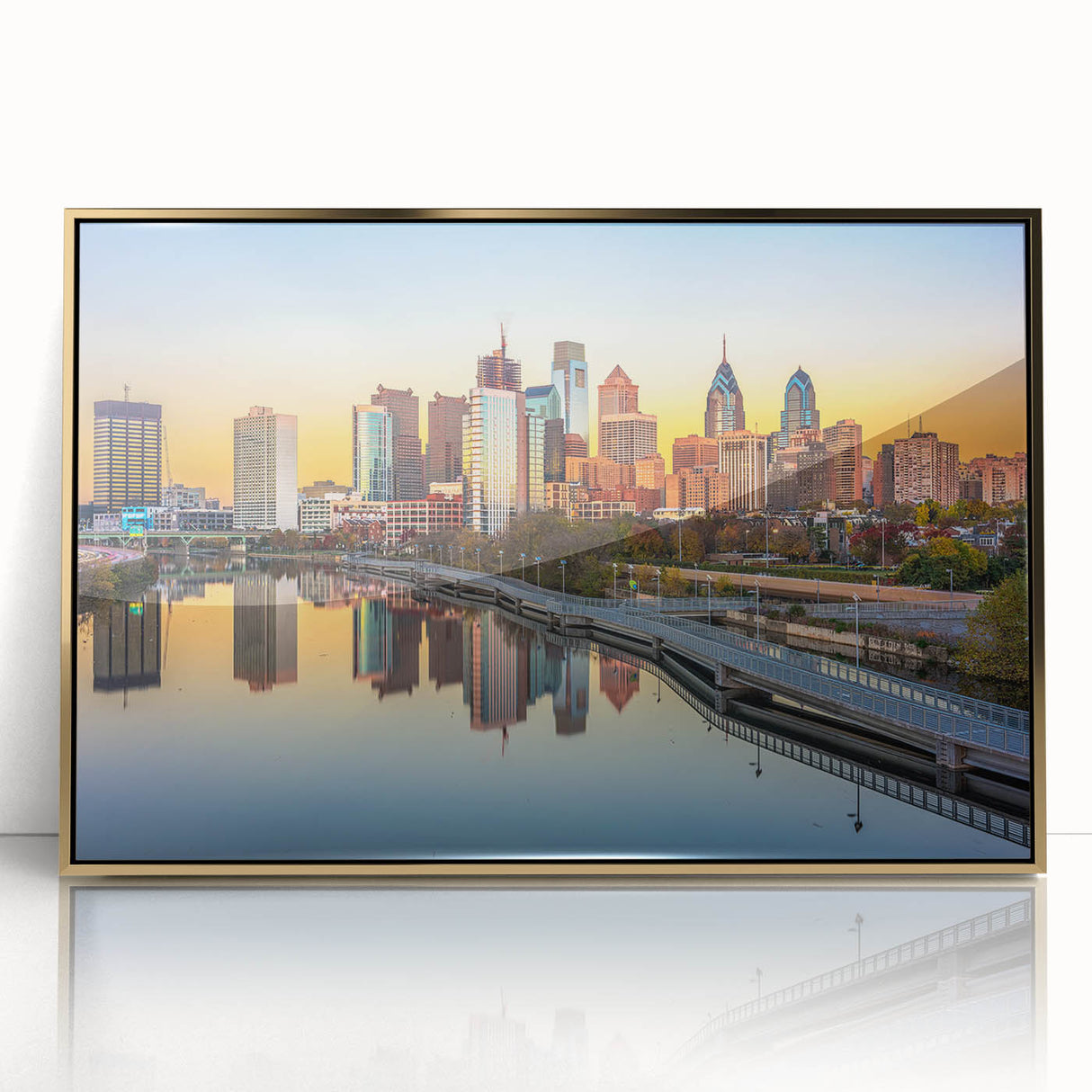Acrylic print of Philadelphia skyline in gold and blue tones, framed, mid-century modernist style.