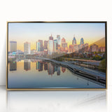 Acrylic print of Philadelphia skyline in gold and blue tones, framed, mid-century modernist style.