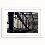 Abstract art print of Pittsburgh skyline in muted gray and blue tones on a framed white mat, ideal for dining room decor.