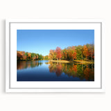 Abstract art print depicting a muted palette of blues and grays, framed in white, suitable for dining room or bedroom.