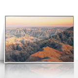 Acrylic print of Badlands landscape in muted earth tones, framed in white, suitable for modern art wall decor.
