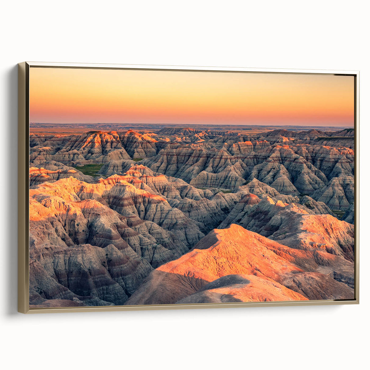 Framed canvas featuring a vintage-style landscape painting of the South Dakota Badlands in black and gold tones.