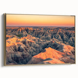 Framed canvas featuring a vintage-style landscape painting of the South Dakota Badlands in black and gold tones.