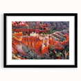Extra large, colorful abstract art print of Bryce Canyon, in vibrant red and orange tones, framed in black.