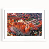 Abstract art print of Bryce Canyon in muted orange and red hues on a white framed mat, ideal for dining room decor.