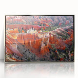 Mid-century modernist art depicting Bryce Canyon in muted orange and red tones on a silver-framed acrylic print.