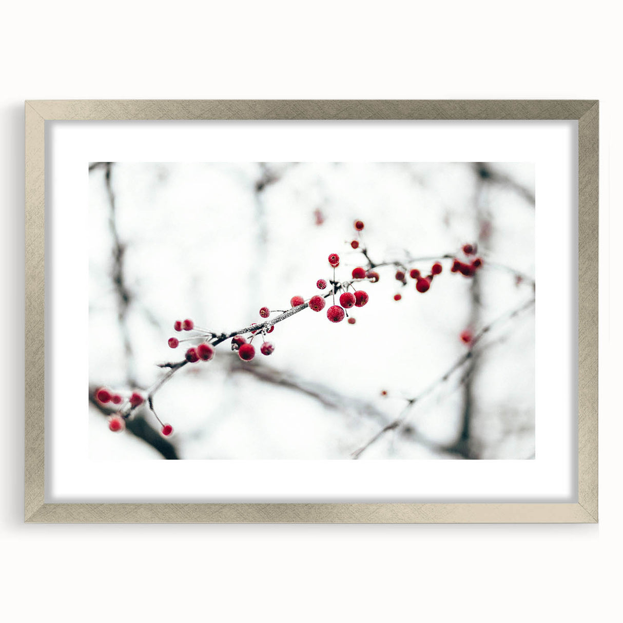 Textured abstract art print depicting a winter scene in muted blue and white tones, framed in silver.