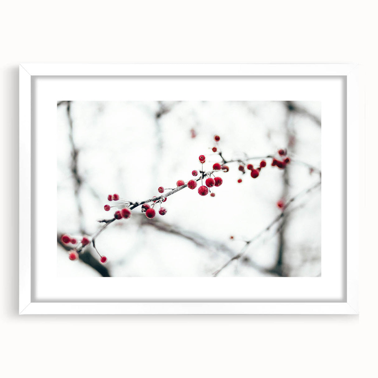 Abstract art print depicting a winter scene in muted blue and gray tones, framed with a white mat.