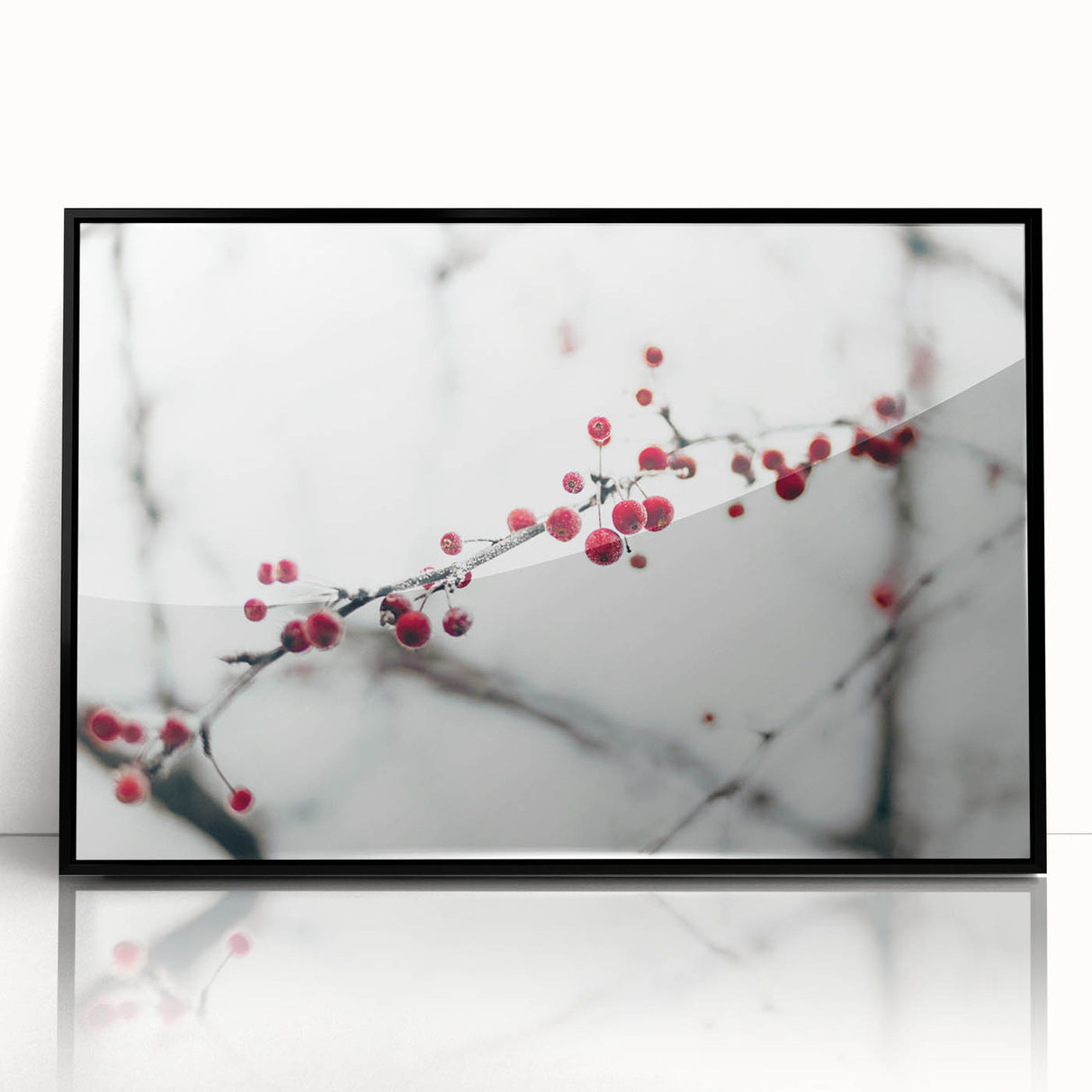 Large abstract wall art depicting a winter scene in muted blue and white tones, framed in black acrylic.